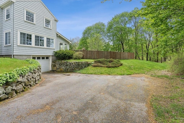 view of yard with driveway and an attached garage