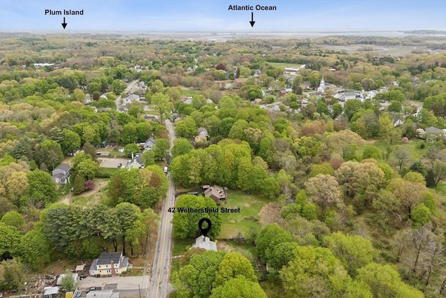 view of property location with a forest