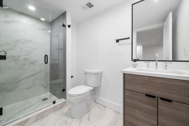 bathroom with vanity, a shower with shower door, and toilet