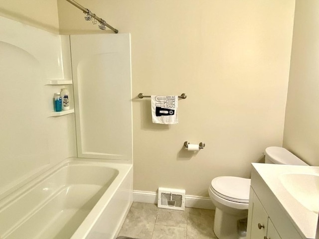 bathroom featuring toilet, tile patterned floors, baseboards, vanity, and washtub / shower combination