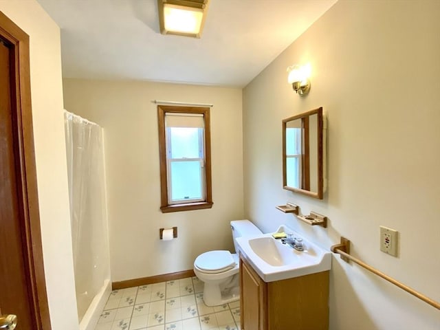 bathroom featuring tile patterned floors, toilet, vanity, a shower with shower curtain, and baseboards