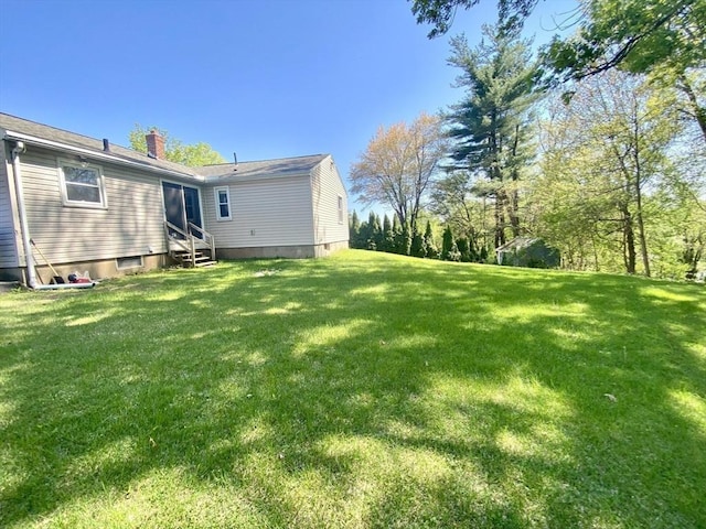 view of grassy yard featuring entry steps