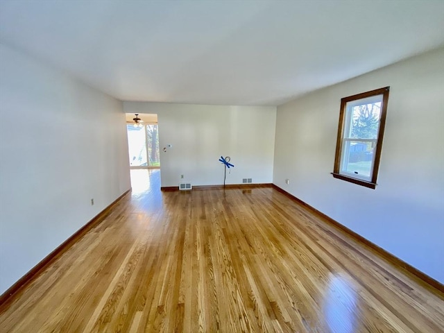 empty room featuring light wood-style flooring and baseboards