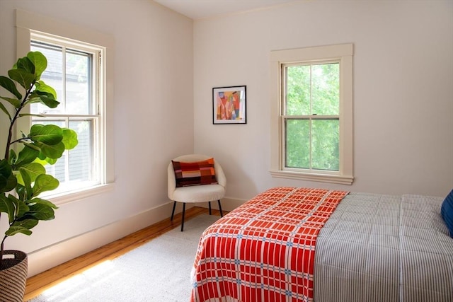 24 Foster St, Cambridge, MA 02138 - bedroom with multiple windows and wood finished floors