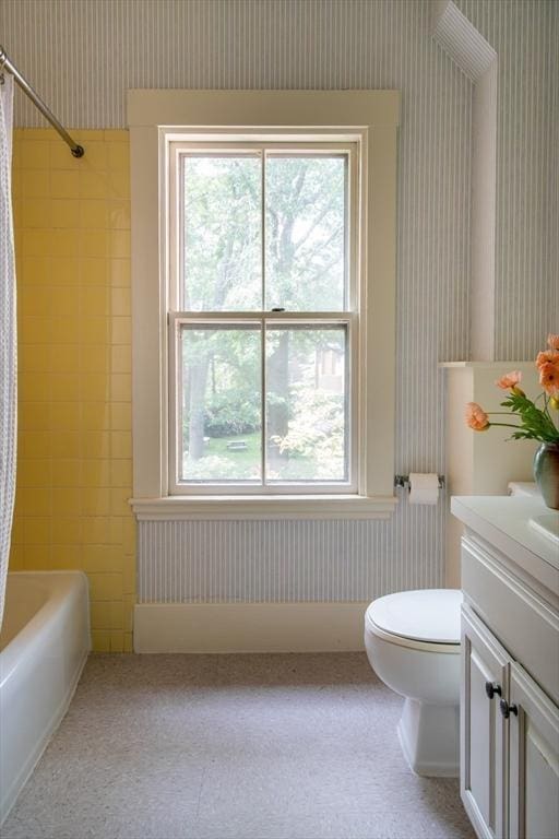 24 Foster St, Cambridge, MA 02138 - full bathroom with wallpapered walls, vanity, healthy amount of natural light, shower / tub combo, and wainscoting
