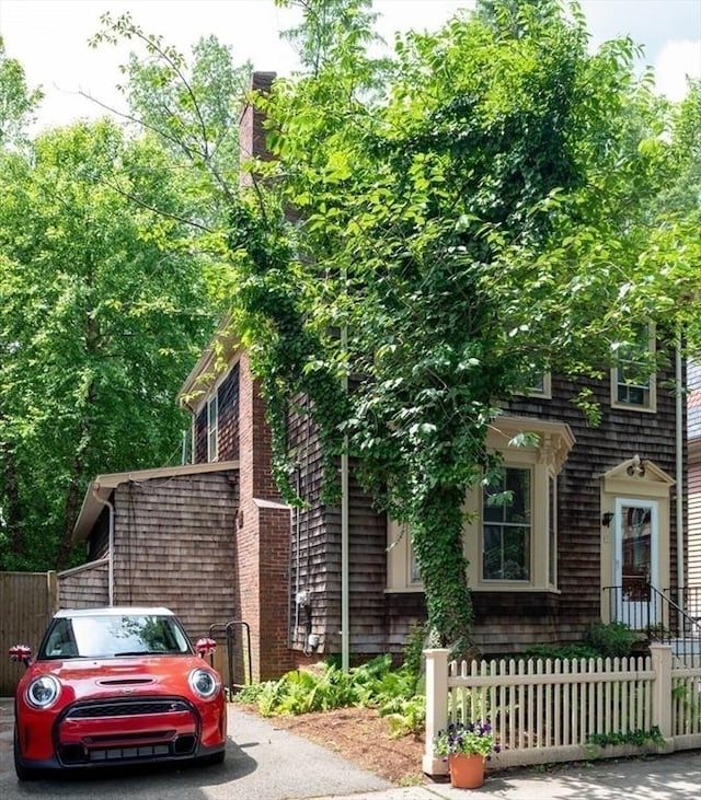 24 Foster St, Cambridge, MA 02138 - view of front of property with a fenced front yard and a chimney