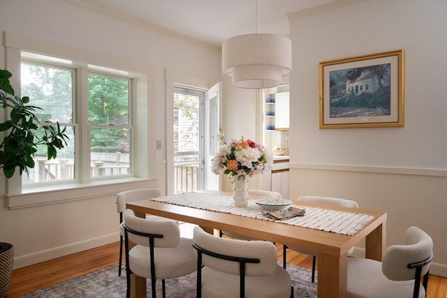 24 Foster St, Cambridge, MA 02138 - dining area with light wood-style floors, healthy amount of natural light, and ornamental molding
