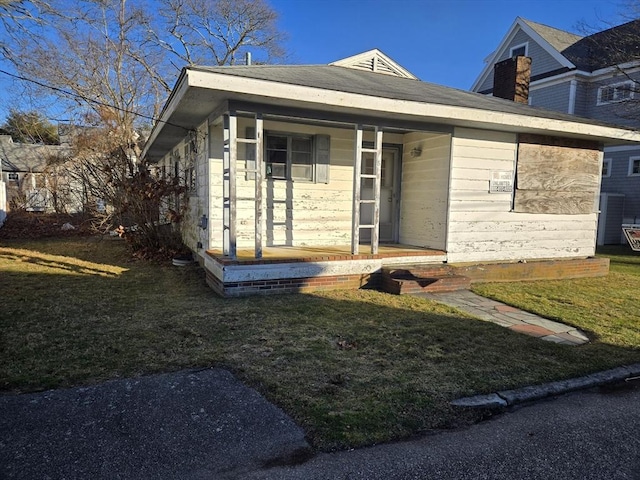 view of front of home with a front yard and a porch