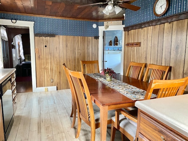 dining room with wooden ceiling, ceiling fan, light wood-type flooring, and wood walls