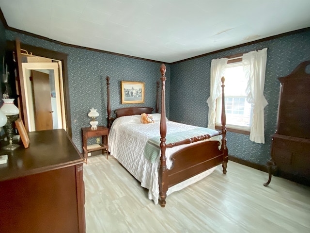 bedroom featuring ornamental molding and light hardwood / wood-style flooring