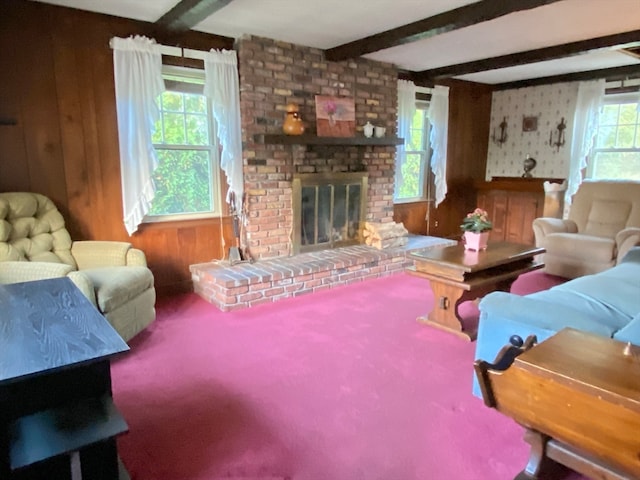 carpeted living room featuring a wealth of natural light, beam ceiling, and a fireplace