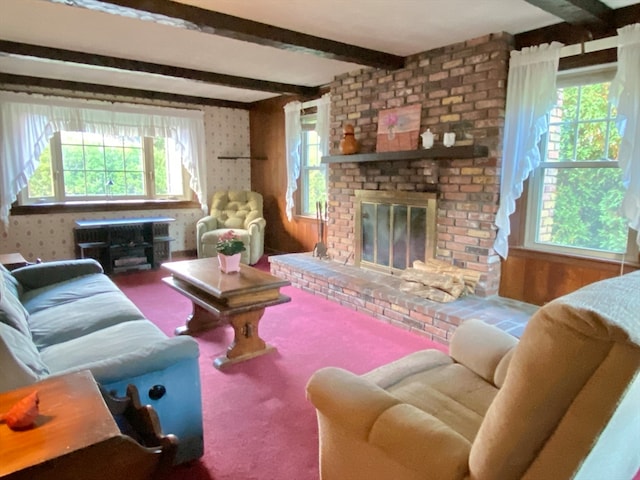 living room with beamed ceiling, carpet, and a brick fireplace