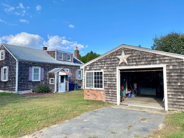 view of property featuring a front yard and a garage