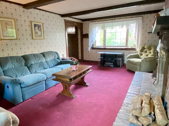 living room featuring beam ceiling, ornamental molding, and carpet