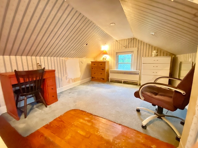 sitting room with radiator, carpet, and lofted ceiling