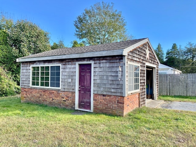 view of outdoor structure featuring a lawn