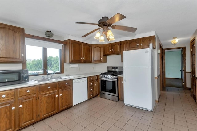 kitchen featuring white appliances, a sink, light countertops, and light tile patterned flooring