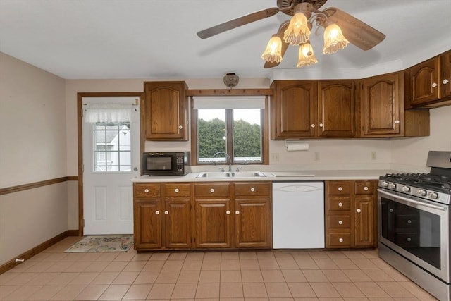 kitchen with white dishwasher, stainless steel range with gas cooktop, a sink, black microwave, and a ceiling fan