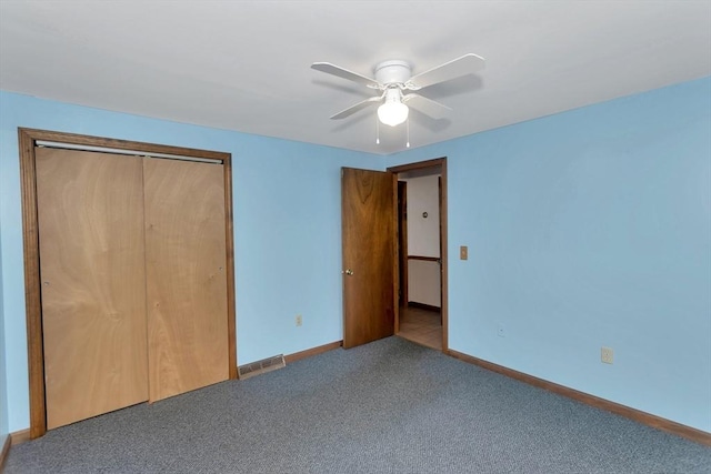 unfurnished bedroom with carpet, baseboards, a closet, and a ceiling fan
