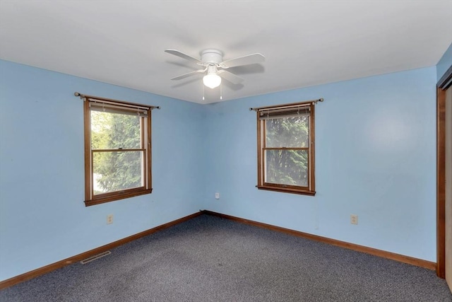 spare room featuring carpet flooring, baseboards, and ceiling fan