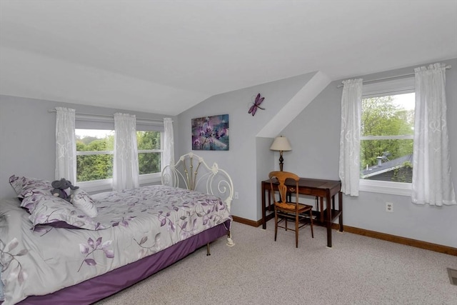 bedroom with lofted ceiling, carpet flooring, and baseboards