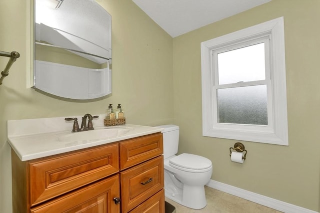 bathroom featuring toilet, baseboards, and vanity