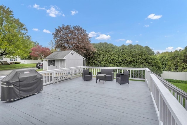 wooden terrace featuring an outdoor living space, area for grilling, an outbuilding, and fence