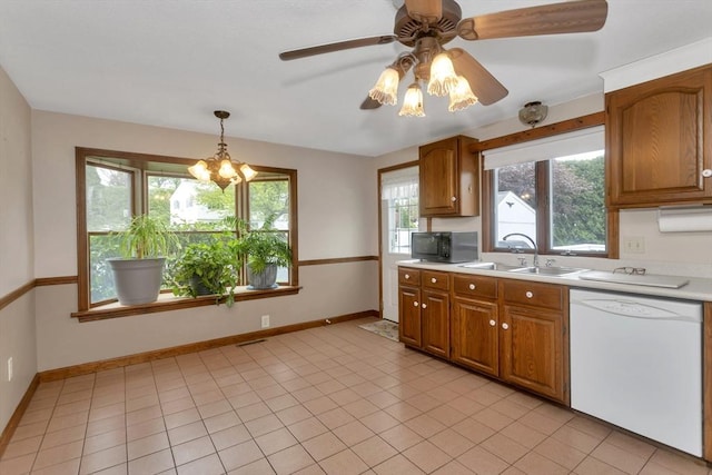 kitchen with dishwasher, black microwave, a sink, light countertops, and a ceiling fan