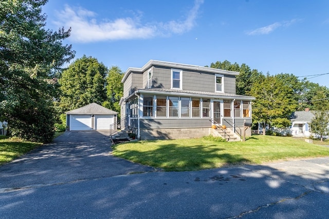 view of front of home featuring a front yard, an outdoor structure, and a garage