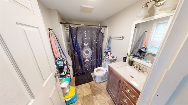 bathroom with vanity, toilet, and a shower with curtain