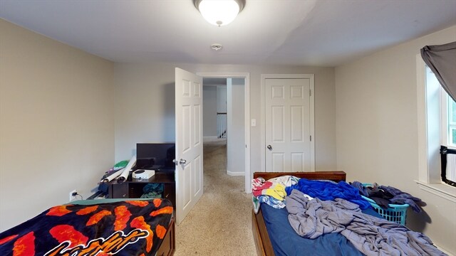 bedroom featuring light colored carpet