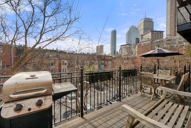 wooden terrace featuring a grill