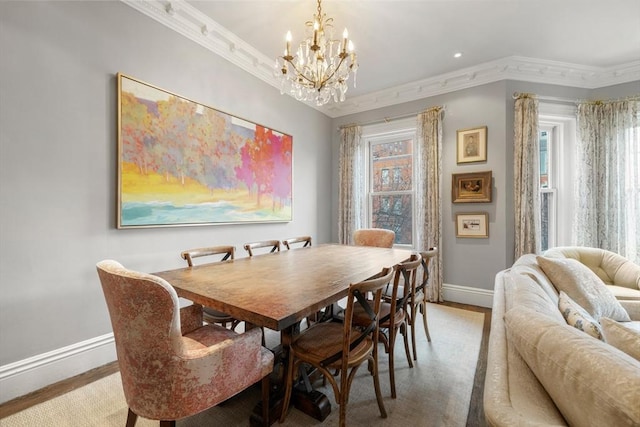 dining space featuring hardwood / wood-style flooring, plenty of natural light, crown molding, and an inviting chandelier