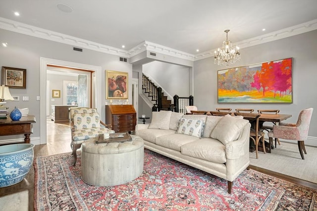 living room featuring a chandelier, crown molding, and wood-type flooring