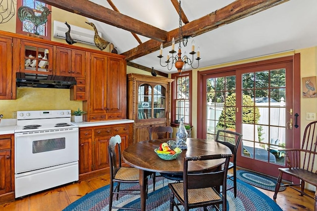 kitchen featuring electric stove, light countertops, a chandelier, light wood-type flooring, and under cabinet range hood