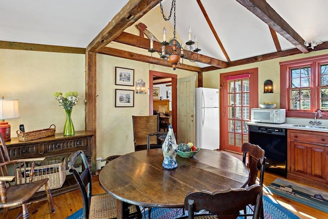 dining room with vaulted ceiling with beams and wood finished floors