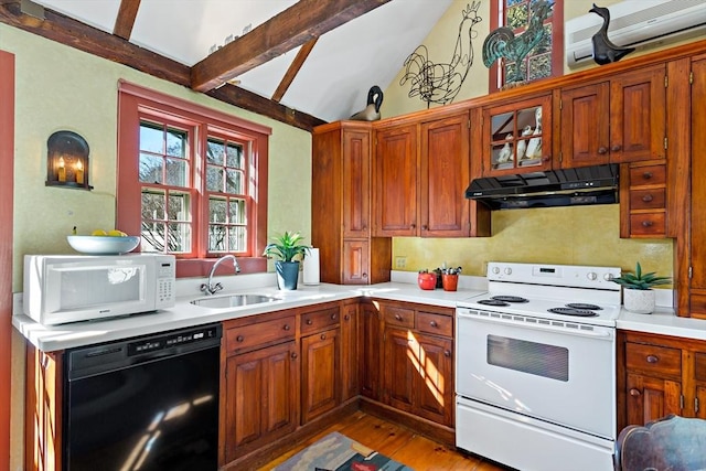 kitchen featuring light countertops, white appliances, a sink, and under cabinet range hood