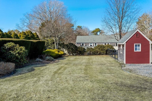 view of yard featuring fence and an outdoor structure