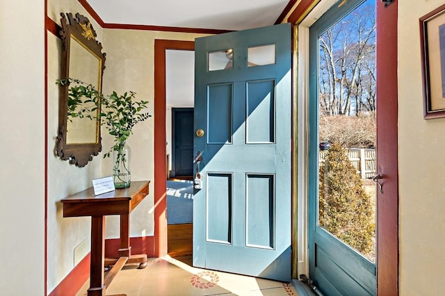 doorway to outside with ornamental molding