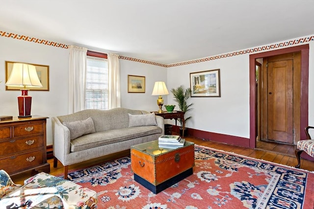 living room with wood-type flooring and baseboards