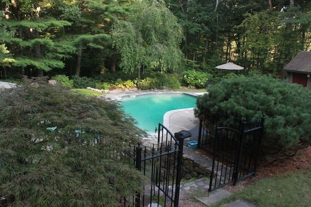 outdoor pool featuring fence