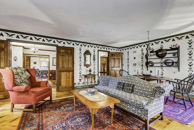 living room featuring ornamental molding and wood finished floors