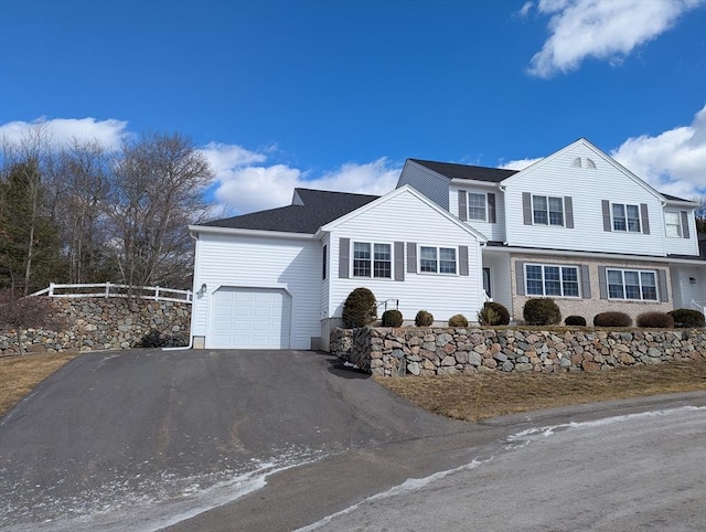 view of front of house featuring driveway and fence