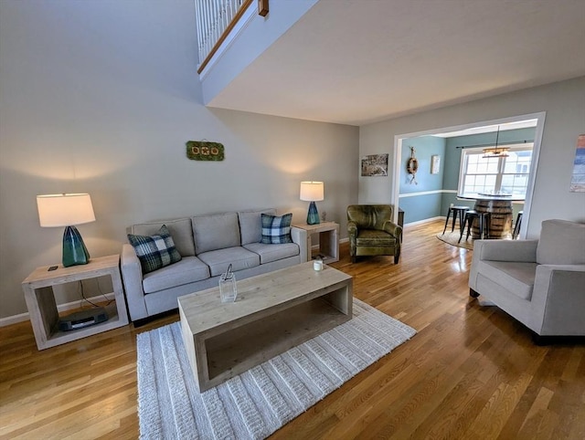 living area featuring baseboards and wood finished floors