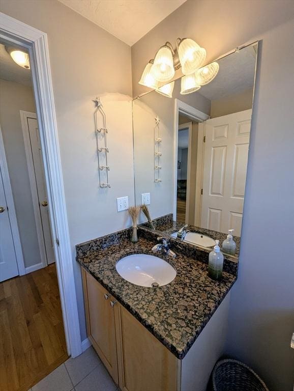 bathroom with tile patterned flooring, vanity, and baseboards