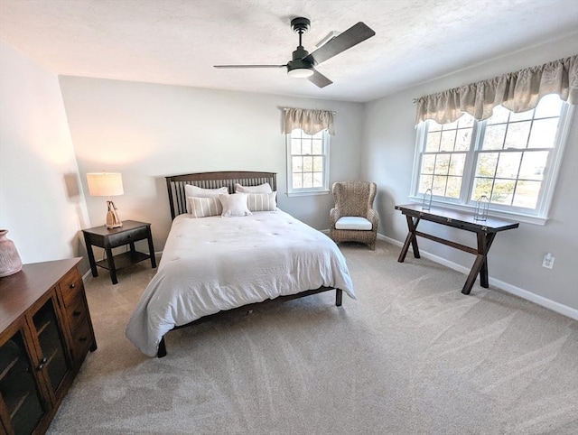 carpeted bedroom featuring a ceiling fan, baseboards, and a textured ceiling