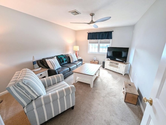 living room featuring light colored carpet, visible vents, ceiling fan, and baseboards