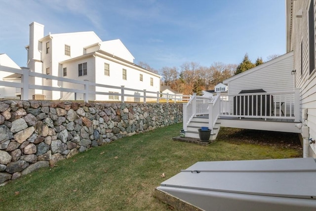 view of yard featuring fence and a deck