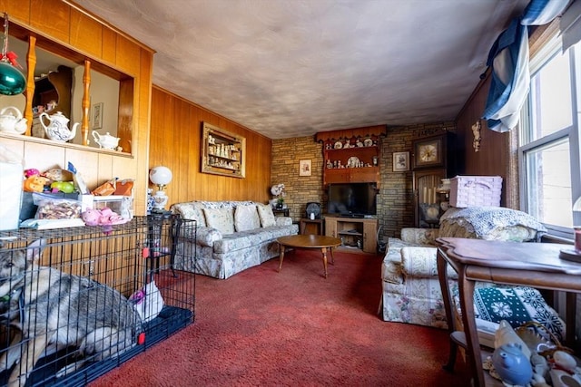 carpeted living room with wood walls