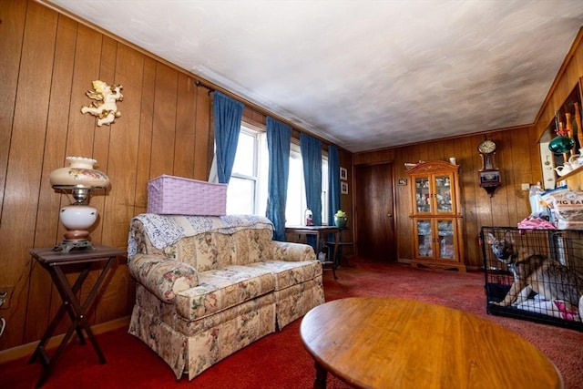 carpeted living room with ornamental molding and wood walls